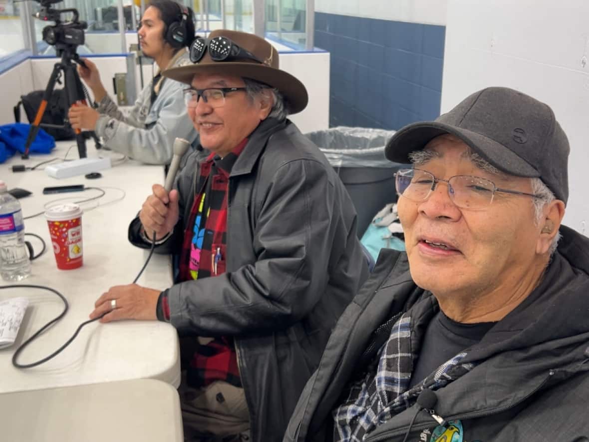 Brothers Hammond Dick and Testloa Smith are broadcasting some of the tournament games in Kaska. To do so they translated 20 pages of hockey terms into Kaska. (George Maratos/CBC News - image credit)