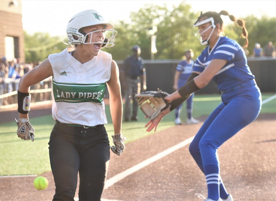 Hamlin's Emalee Duniven, left, celebrates after scoring the game's first run on a two-out wild pitch in the first inning against Stamford.