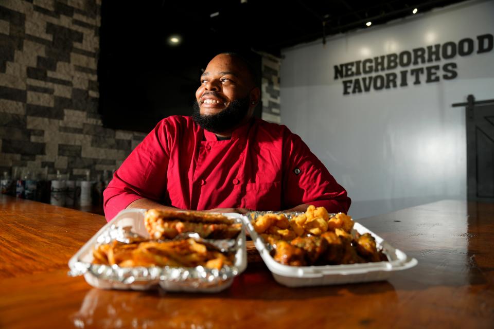 Randy Morrison opened Neighborhood Favorites this summer, at 283 Clinton Ave. in Newark. He poses for a photograph here with the lobster grill cheese and the shrimp. Monday, July 31, 2023