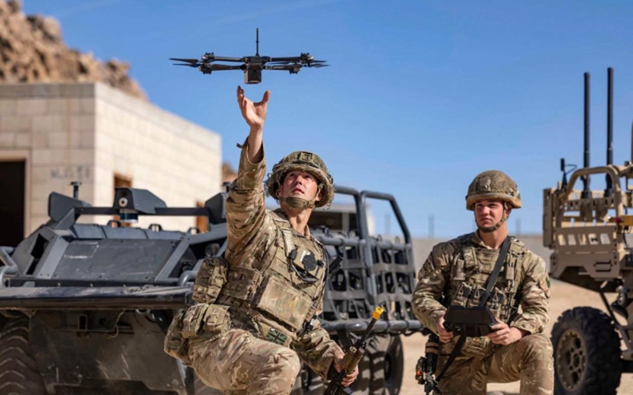 British soldiers launch a drone during Project Convergence exercises at Fort Irwin