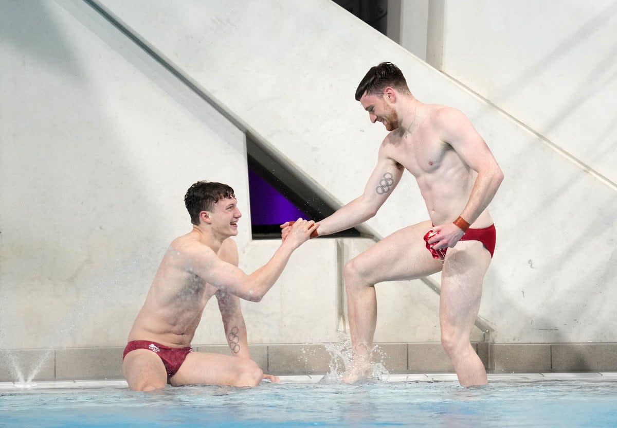 Matty Lee and Noah Williams celebrate clinching gold with their final dive (PA)