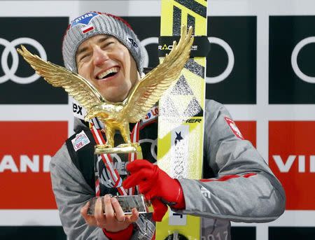 Ski Jumping - 65th four-hills ski jumping tournament final round - Bischofshofen, Austria - 06/01/2017 - Poland's Kamil Stoch celebrates after winning the 65th four-hills tournament. REUTERS/Dominic Ebenbichler