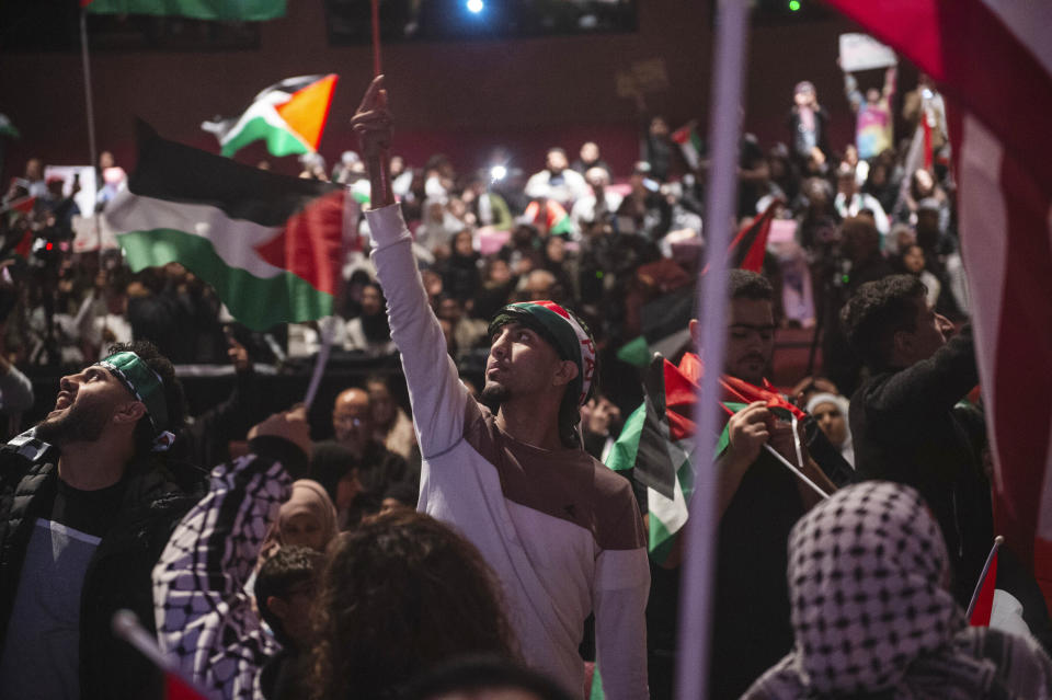 Attendees wave flags and fly signs during a rally in support of Palestine in Dearborn, Detroit on Tuesday, Oct. 10, 2023. Many top Michigan Democrats, including Gov. Gretchen Whitmer, took part in a huge pro-Israel rally near Detroit after the Hamas Oct. 7 attack on the country. None of them attended a rally in nearby Dearborn the next day to show support for Palestinians in Gaza being killed or forced from their homes by the Israeli military’s response. The war has inflamed tensions between Jews and Muslims everywhere, including the Detroit area, which is home to several heavily Jewish suburbs and Dearborn, the city with the largest concentration of Arab Americans in the U.S. (Matthew Hatcher/Detroit News via AP)