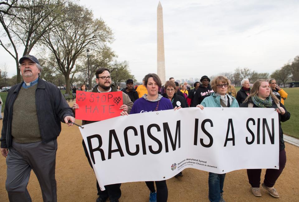 <p>People commemorating the 50th anniversary of the assassination of Rev. Martin Luther King, Jr., hold a silent prayer walk from the Martin Luther King Jr. Memorial past the Washington Monument to the National Mall in Washington, April 4, 2018. (Photo: Saul Loeb/AFP/Getty Images) </p>