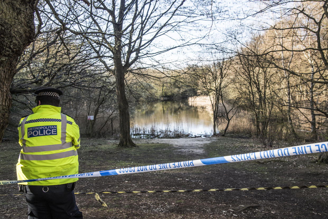 A Metropolitan Police officer at the scene at the Wake Valley pond in Epping Forest.