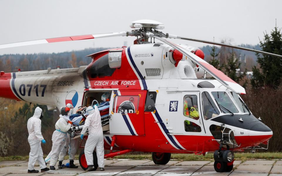Medical workers transport a Covid patient from a Brno hospital by a Czech Air Force helicopter, in Prague, Czech Republic on November 25 2021. - David W Cerny/Reuters