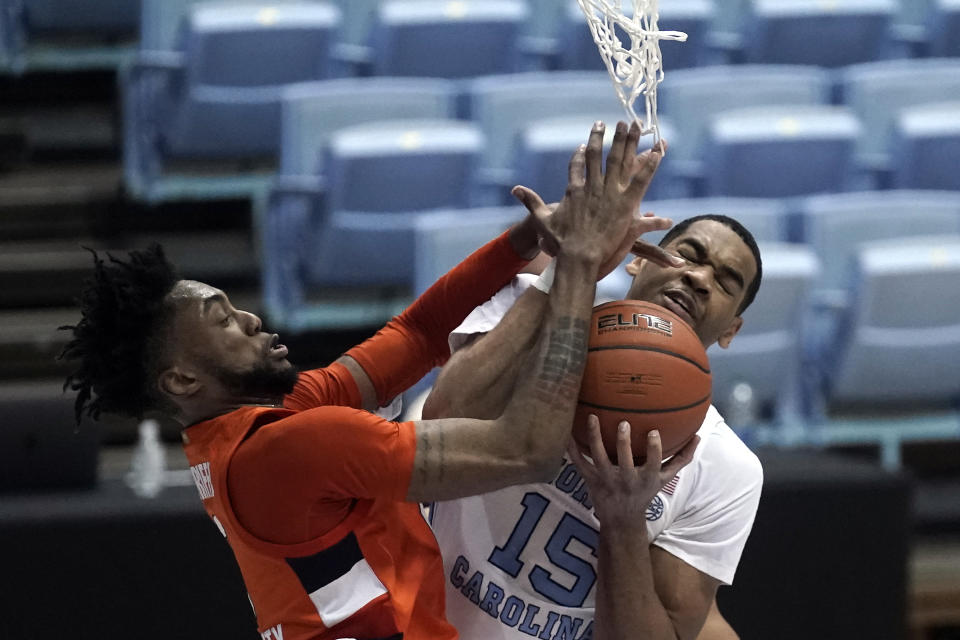 Syracuse forward Alan Griffin and North Carolina forward Garrison Brooks (15) struggle for a rebound during the second half of an NCAA college basketball game in Chapel Hill, N.C., Tuesday, Jan. 12, 2021. (AP Photo/Gerry Broome)