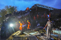 Rescuers carry the body of a victim at the site of passenger trains that derailed in Balasore district, in the eastern Indian state of Orissa, Saturday, June 3, 2023. Rescuers in India have found no more survivors in the overturned and mangled wreckage of two passenger trains that derailed, killing more than 280 people and injuring hundreds in one of the country’s deadliest rail crashes in decades. (AP Photo/Rafiq Maqbool)