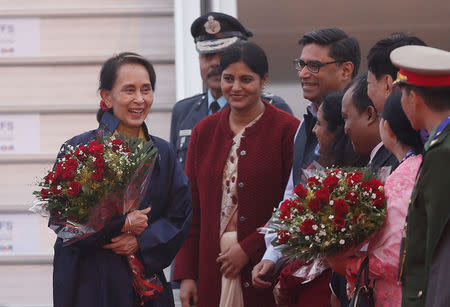 Myanmar's State Counsellor Aung San Suu Kyi (L) smiles after arriving at Air Force Station Palam in New Delhi, India, January 24, 2018. REUTERS/Adnan Abidi