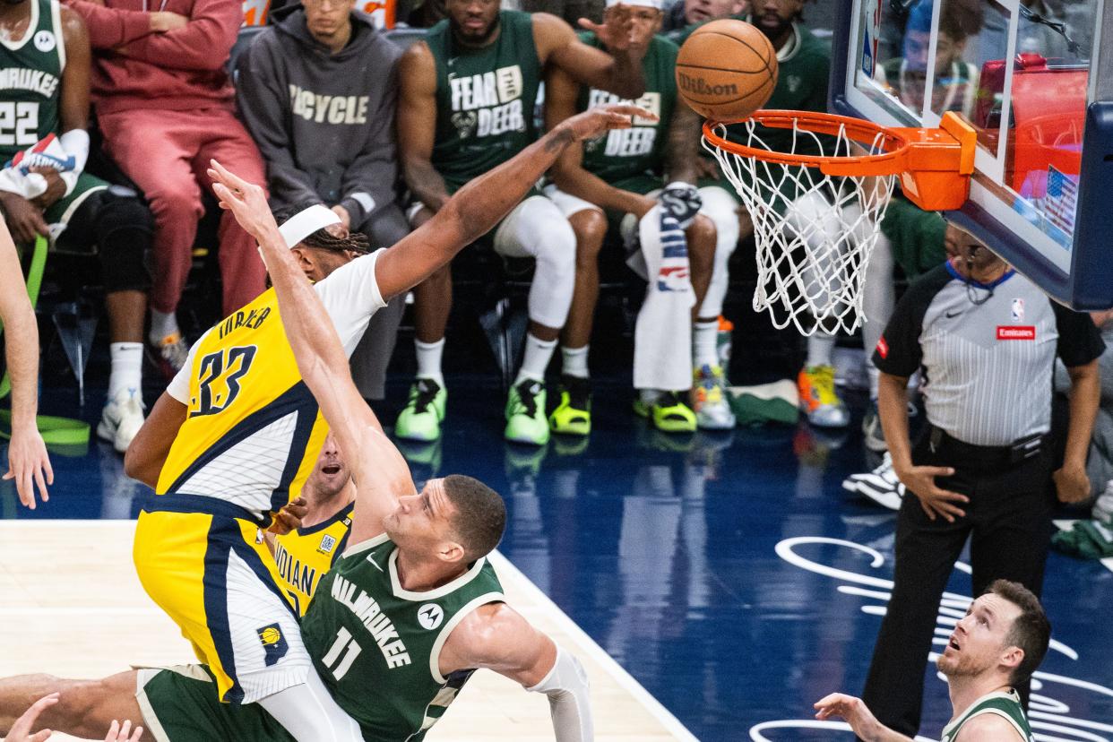 Pacers center Myles Turner puts up a shot in the paint after running into Bucks center Brook Lopez during Game 4 on Sunday night at Gainbridge Fieldhouse.