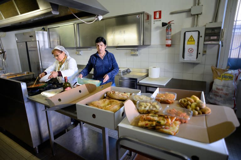 Volunteers at Caritas, a catholic charity, prepare packs of food scraps on May 28, 2013. Organisers of the project entitled "Pasto Buono" ("Good Meal") contact gourmet grocers and restaurants which throw out scraps and day-old food and puts them in touch with organisations such as Caritas that run soup kitchens