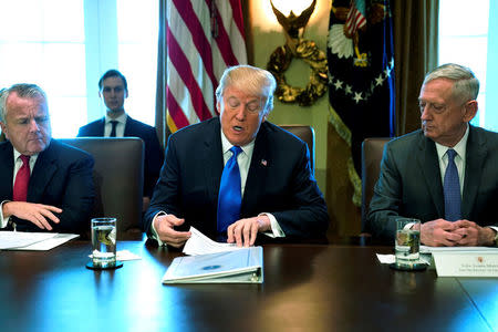 FILE PHOTO: U.S. President Donald Trump, flanked by Deputy Secretary of State John Sullivan (L) and Defense Secretary James Mattis (R), speaks to reporters before he holds a cabinet meeting at the White House in Washington, U.S. December 6, 2017. REUTERS/Jonathan Ernst/File Photo