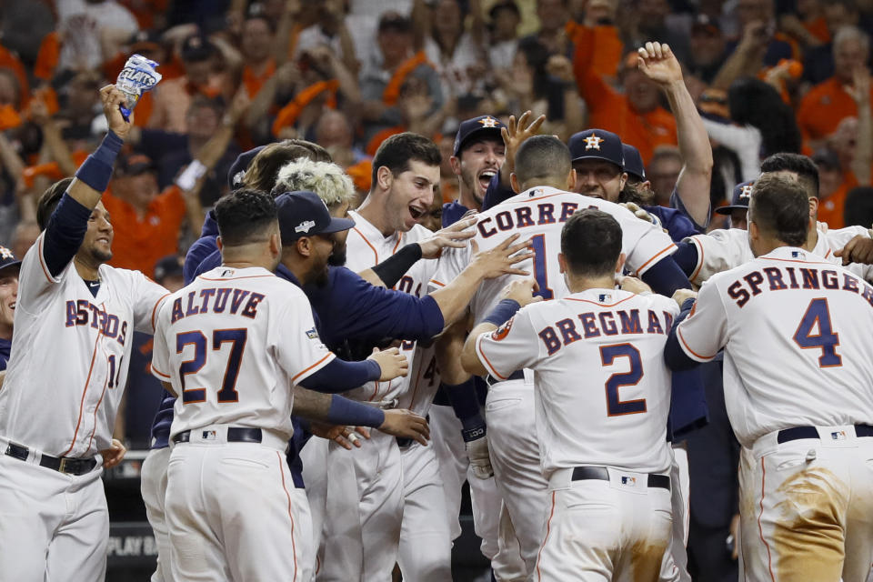 Houston Astros' Carlos Correa celebrates with teammates after his walk-off home run against the New York Yankees during the 11th inning in Game 2 of baseball's American League Championship Series Sunday, Oct. 13, 2019, in Houston. (AP Photo/Eric Gay)