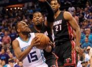 Apr 29, 2016; Charlotte, NC, USA; Charlotte Hornets guard Kemba Walker (15) looks to shoot as he is defended by Miami Heat forward Joe Johnson (2) during the first half in game six of the first round of the NBA Playoffs at Time Warner Cable Arena. Mandatory Credit: Sam Sharpe-USA TODAY Sports