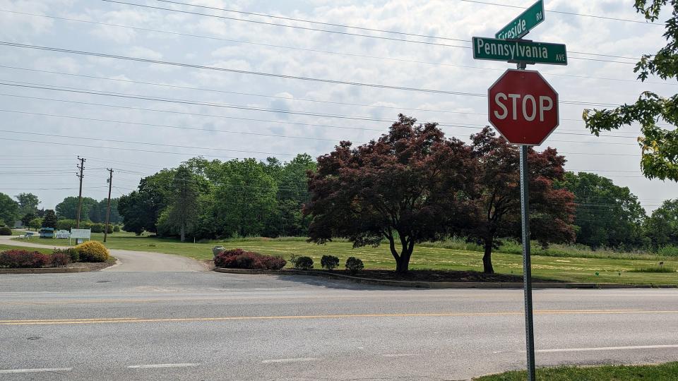 Looking from the residential development of Fireside through the intersection of Fireside Road and Pennsylvania Avenue at the entrance to Prospect Hill Cemetery in York on May 23, 2023. A potential warehouse or other industrial development would be visible where the trees are in the background.