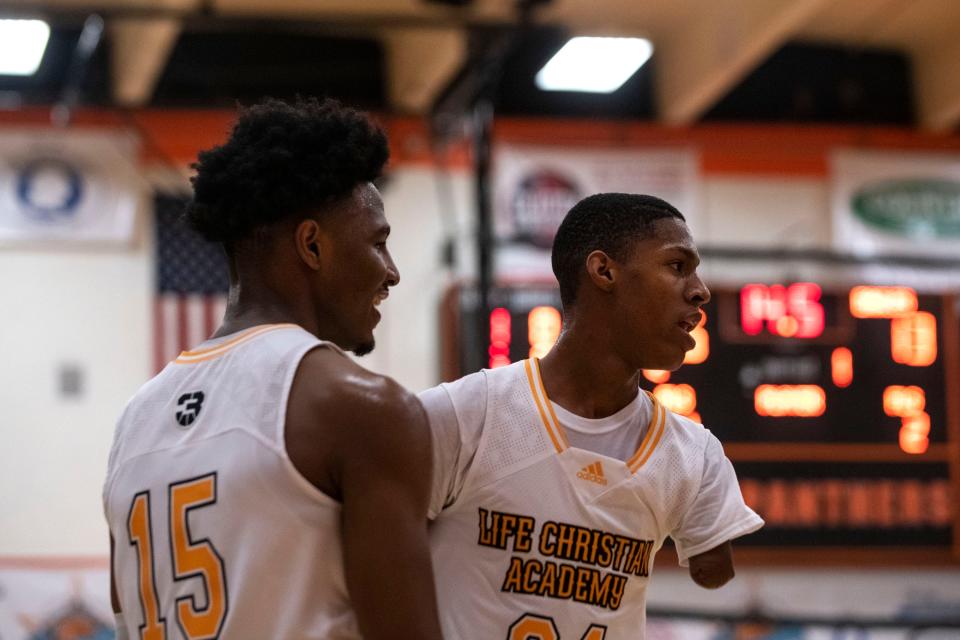 Life Christian Academy players Angel Montas and Hansel-Emmanuel Donato celebrate after scoring during the Kevin Brown Memorial Tournament of Champions match against Rabun Gap on Wednesday, Nov. 24, 2021. The LCA Lions beat the Rabun Eagles 66-63.