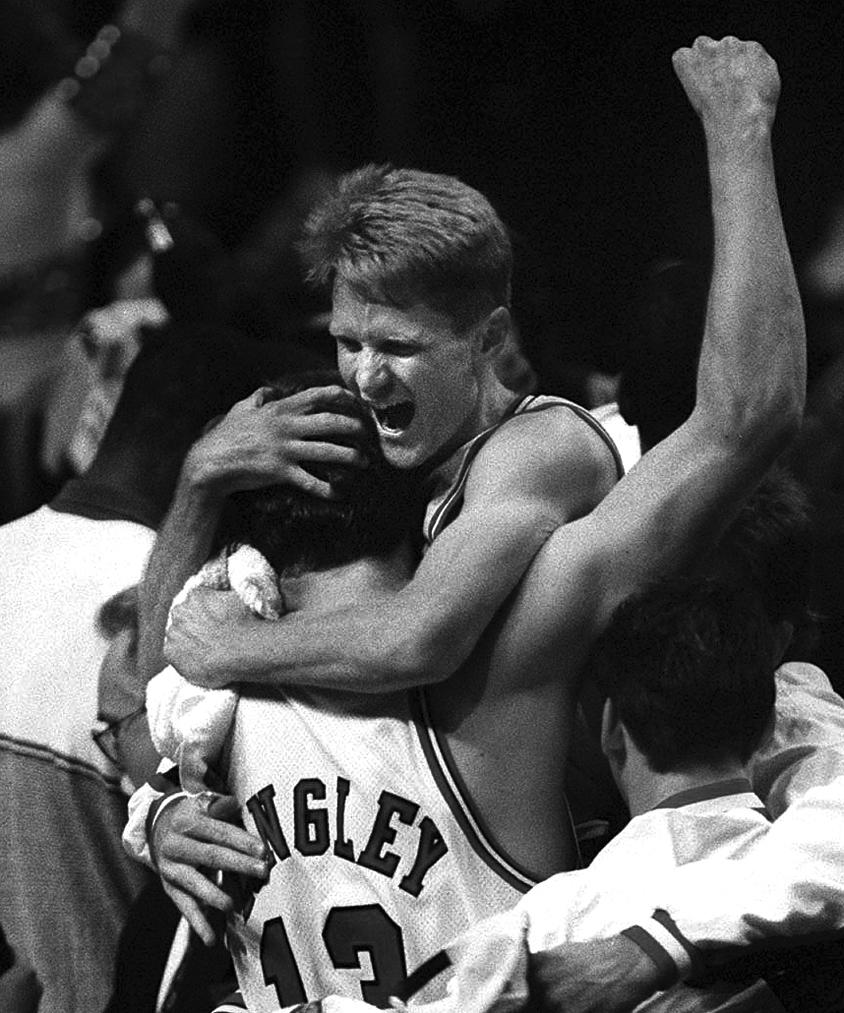 FILE - Chicago Bulls' Steve Kerr hugs teammate Luc Longley after winning the NBA championship by defeating the Seattle Supersonics 87-75 in Chicago, June 16, 1996. The biggest names on the U.S. World Cup roster might be those who’ll be wearing polo shirts instead of jerseys on game days. Steve Kerr is a nine-time NBA champion; five as a player, four as a coach. (Robert A. Davis/Chicago Sun-Times via AP)