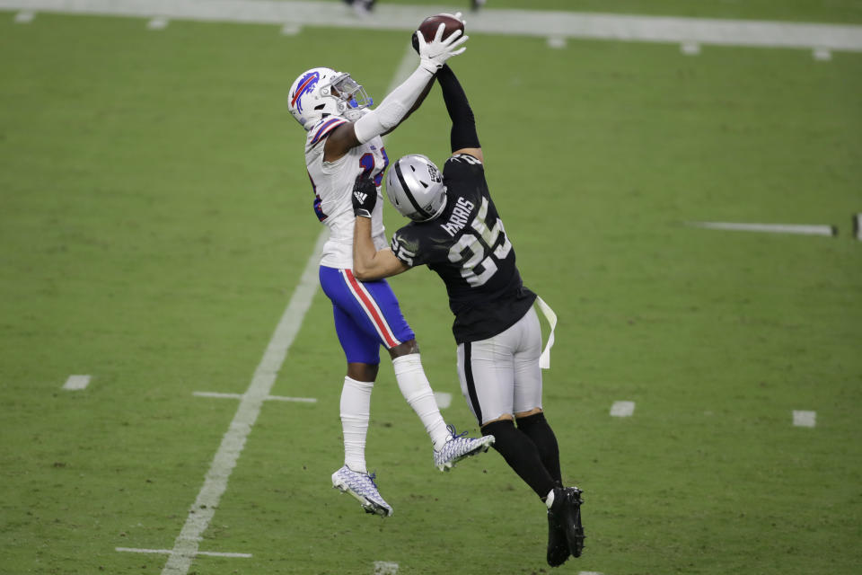 Buffalo Bills wide receiver Stefon Diggs (14) catches a pass over Las Vegas Raiders free safety Erik Harris (25) during the second half of an NFL football game, Sunday, Oct. 4, 2020, in Las Vegas. (AP Photo/Isaac Brekken)