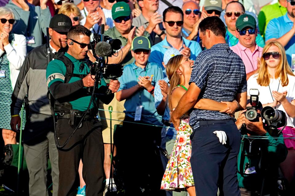 Scottie Scheffler celebrates with his wife, Meredith, after winning the Masters Tournament.