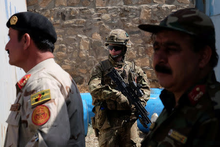 A soldier with the British army's Royal Irish Regiment provides security for a meeting between international military advisers and Afghan officials at a base in Kabul, Afghanistan July 12, 2017. REUTERS/Josh Smith