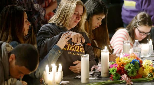 Young People light candles on the stage at the Grove Church in Marysville, Washington, after a memorial vigil held for people affected by a shooting at Marysville Pilchuck High School. Photo: AP/Ted Warren