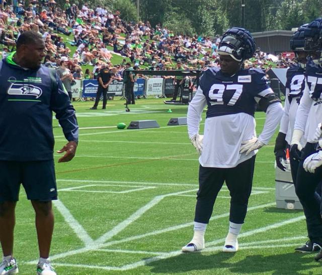 Tackle Poona Ford (97) works defensive-line drills in Seahawks training camp in Renton, Aug. 9, 2022. Ford, entering the final year of his contract, has new roles in Seattle’s new 3-4 scheme. At times he’ll be more outside off the offensive tackle instead of as often over the center as a nose tackle.
