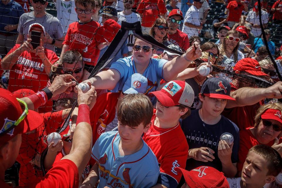 St. Louis Cardinals fans wait for autographs during spring training at Roger Dean Stadium in Jupiter, Fla., on Friday, March 18, 2022.