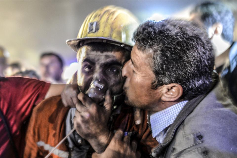 A man kisses his son, rescued of the mine, on May 13, 2014 after an explosion in a coal mine in Manisa. (BULENT KILIC/AFP/Getty Images)