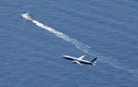 A Japan Coast Guard vessel and a U.S. military aircraft conduct rescue and search operations at the site where an Air Self-Defense Force's F-35A stealth fighter jet crashed during an exercise on April 9, 2019, off Aomori prefecture, Japan, in this photo taken by Kyodo April 10, 2019. Mandatory credit Kyodo/via REUTERS