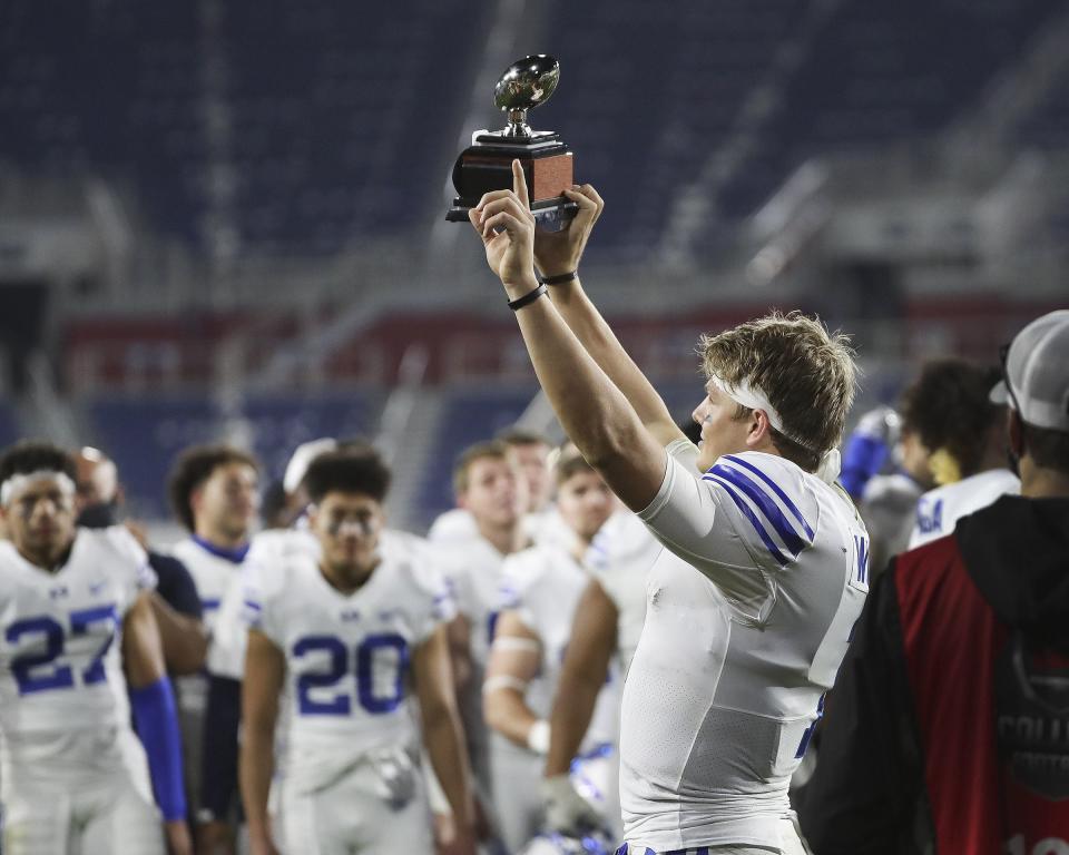 BYU quarterback Zach Wilson holds up the MVP trophy after the Boca Raton Bowl in Boca Raton, Fla., on Tuesday, Dec. 22, 2020. BYU won 49-23. | Jeffrey D. Allred, Deseret News