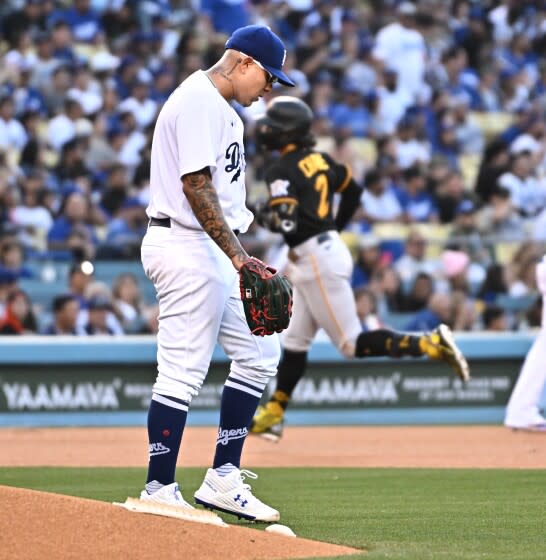 Dodgers pitcher Julio Urias walks back to the mound after giving up a two-run home run to the Pirates Michael Chavis.