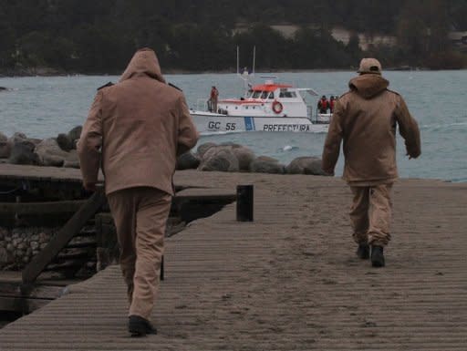 Coast Guard personnel walk on a pier covered with ash to welcome a group of students and workers rescued from the nearby Isla Victoria island, at San Carlos de Bariloche, Rio Negro, Argentina, on June 9. Those rescued had been stranded in the island since the eruption of Chile's Puyehue volcano, on June 4
