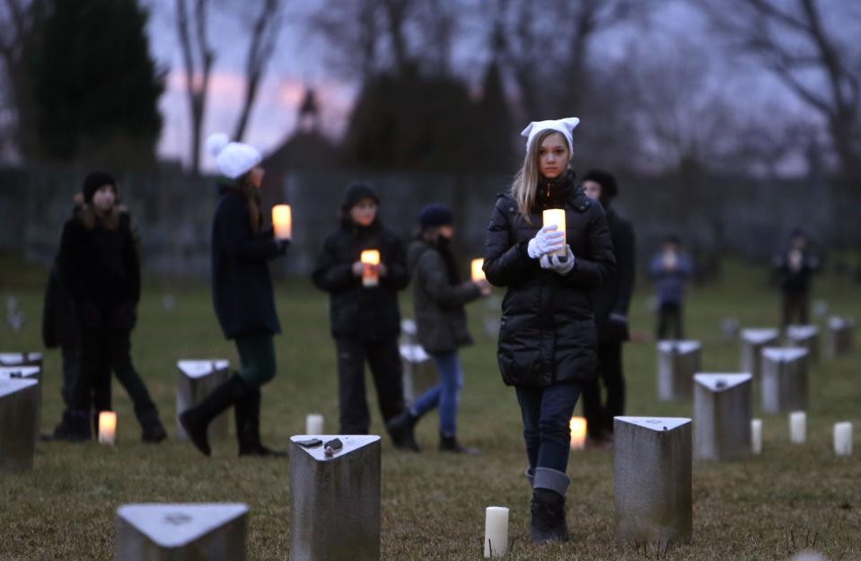 Children place candles during a commemoration ceremony for the 70th anniversary of the liberation of Auschwitz death camp, at the Jewish Cemetery in former Nazi concentration camp Terezin in Terezin