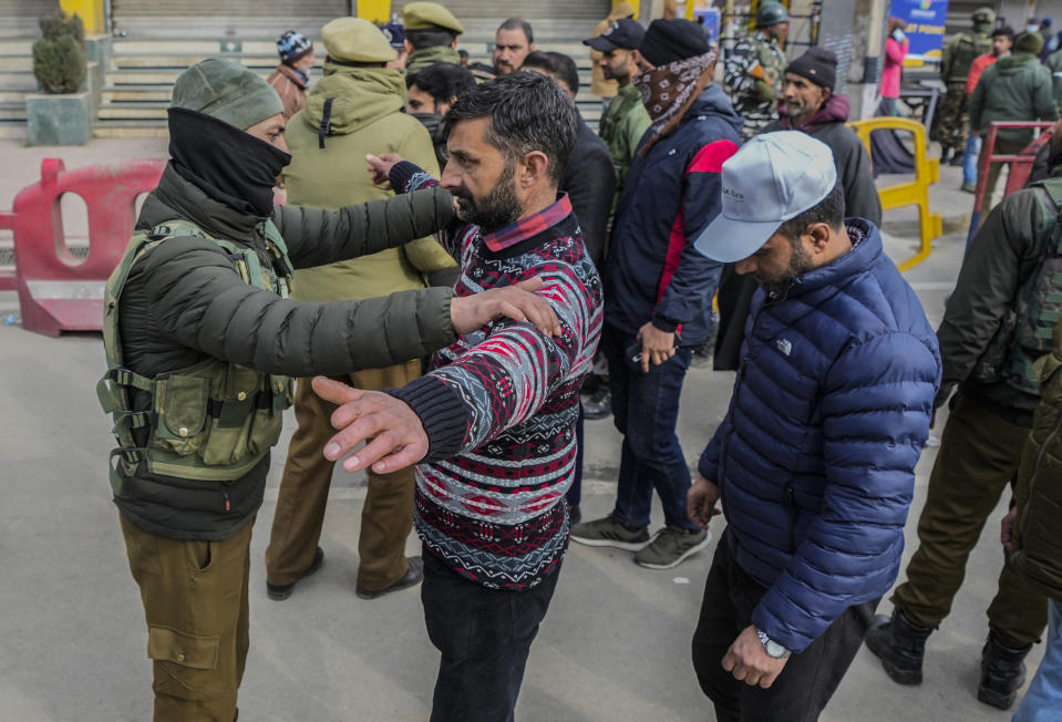 Policemen frisk people in a queue outside a venue where Indian Prime Minister Narendra Modi is scheduled to address a public rally Srinagar, Indian controlled Kashmir, Thursday, March 7, 2024. Modi on Thursday is making his first official visit to Kashmir’s main city since New Delhi stripped the disputed region’s semi-autonomy and took direct control of it in 2019. (AP Photo/Mukhtar Khan)