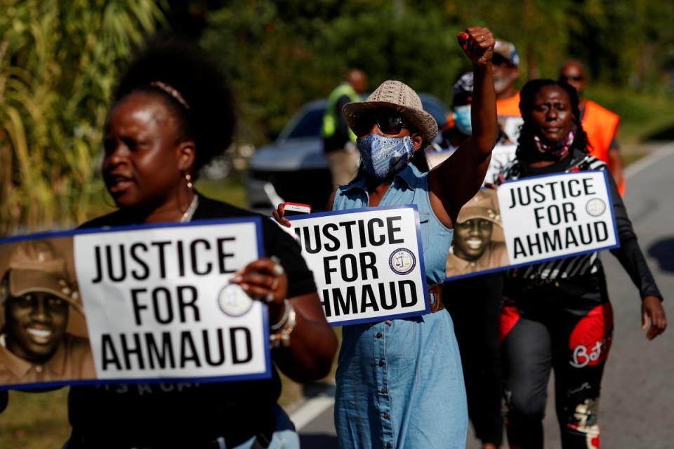 Protesters holding signs calling for Justice for Ahmaud Arbery (REUTERS)