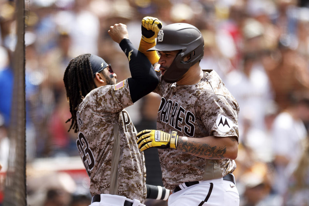 San Diego Padres' Gary Sanchez, left, and Josh Hader shake hands after the  team defeated the Texas Rangers in a baseball game Sunday, July 30, 2023,  in San Diego. (AP Photo/Derrick Tuskan