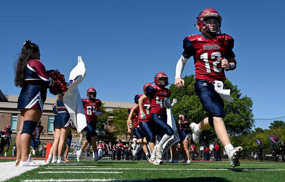 Westborough quarterback Andrew Pisciotta (12) and teammates take to the field to take on Hopkinton  a non-league game at Westborough High School, Sept. 24, 2022.   Saturday's matchup was the first meeting between the Rangers and Hillers football teams since 1958.