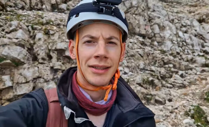 Head shot of Cristea wearing a climbing helmet and headlamp.