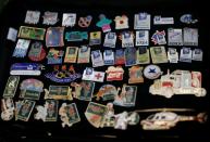 Yoshiyuki Terajima, a pin collector based in Tokyo, displays his Olympic pin collection near the National Stadium in Tokyo