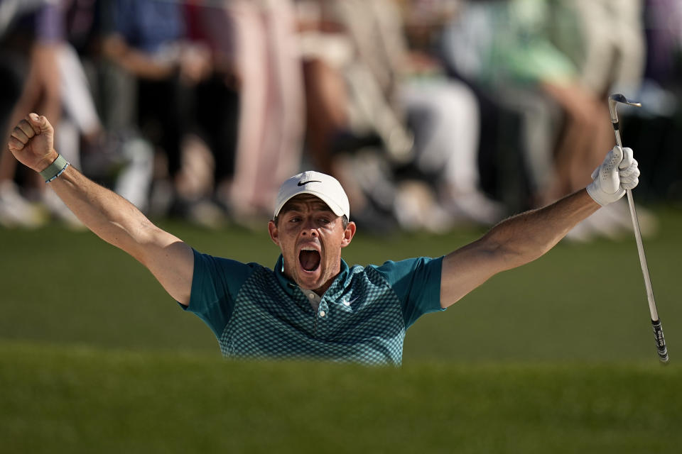 Rory McIlroy, of Northern Ireland, reacts after holing out from the bunker for a birdie during the final round at the Masters golf tournament on Sunday, April 10, 2022, in Augusta, Ga. (AP Photo/David J. Phillip)