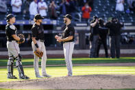 Miami Marlins relief pitcher Anthony Bass (52) waits for umpires to review a hit-by-pitch call against New York Mets' Michael Conforto that resulted in the winning run scored with the bases loaded during the ninth inning of a baseball game, Thursday, April 8, 2021, in New York. (AP Photo/John Minchillo)