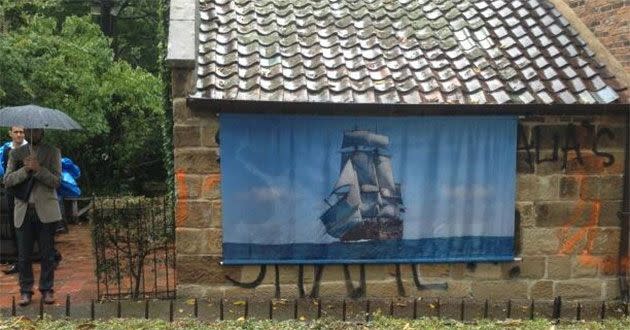 Staff at Captain Cook's cottage cover up graffiti with the Endeavour. Photo: Twitter (@NickMcCallum7)
