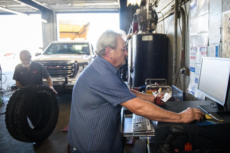 Mechanic John Green demonstrates how an emissions test is done at Tire Sales & Service on Person St., Monday, Oct. 2, 2023.