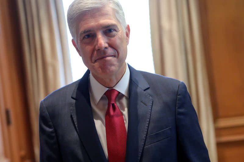 FILE PHOTO: U.S. Supreme Court Justice Neil Gorsuch poses for a picture in his chambers at the Supreme Court building in Washington
