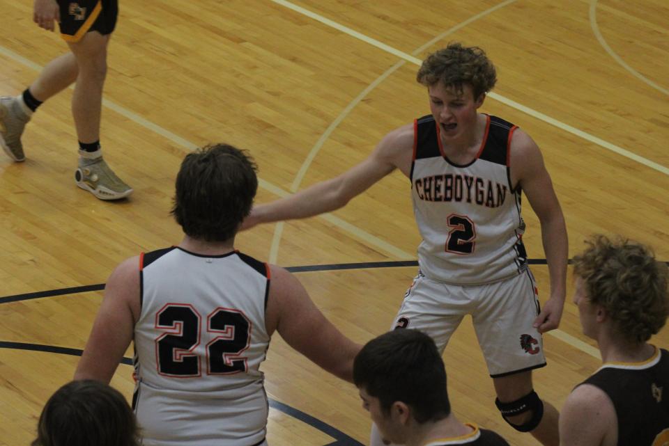 Cheboygan senior Connor Gibbons (2) congratulates junior teammate Dylan Balazovic (22) after Balazovic scored a basket and was fouled during the first half against Ogemaw on Tuesday.