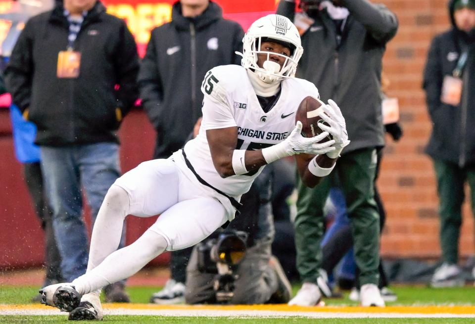 Oct 28, 2023; Minneapolis, Minnesota, USA; Michigan State Spartans wide receiver Jaron Glover (15) catches a pass against the Minnesota Golden Gophers during the fourth quarter at Huntington Bank Stadium. Mandatory Credit: Nick Wosika-USA TODAY Sports