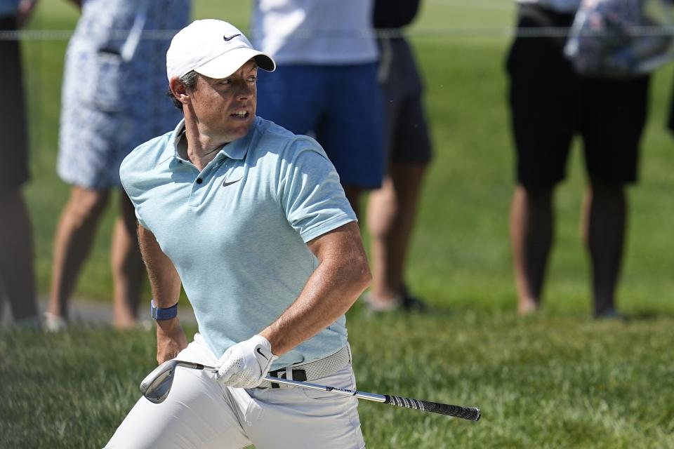 Rory McIlroy, of Northern Ireland, looks at his shot out of a bunker on the 13th green during the first round of the Memorial golf tournament, Thursday, June 1, 2023, in Dublin, Ohio. (AP Photo/Darron Cummings)