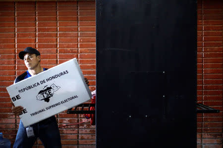 A worker unloads election materials for distribution at voting stations ahead of the November 26 presidential election in Tegucigalpa, Honduras, November 25, 2017. REUTERS/Edgard Garrido