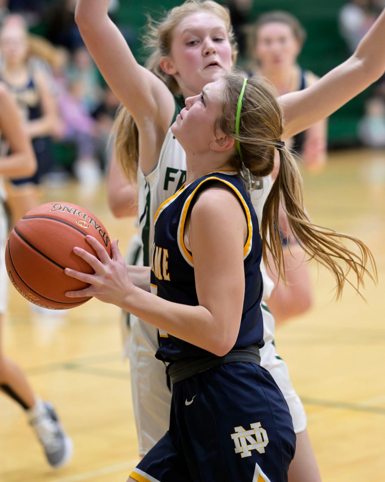 Notre Dame's Anna Engberg looks for a shot against West Burlington's Taryn Havener Tuesday at West Burlington.