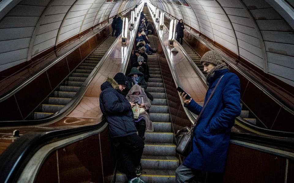 Residents take shelter in a metro station during an air strike alarm in Kyiv - AFP via Getty Images